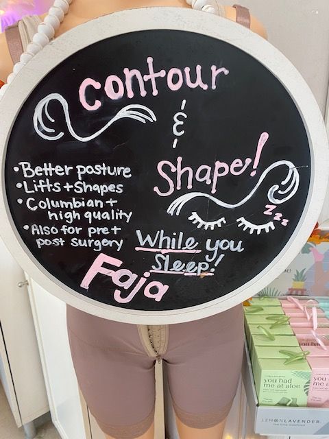 A woman is holding a dumbbell in a gym.