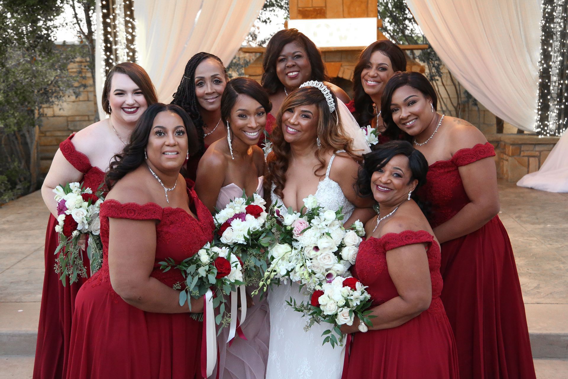 A bride and her bridesmaids are posing for a picture.