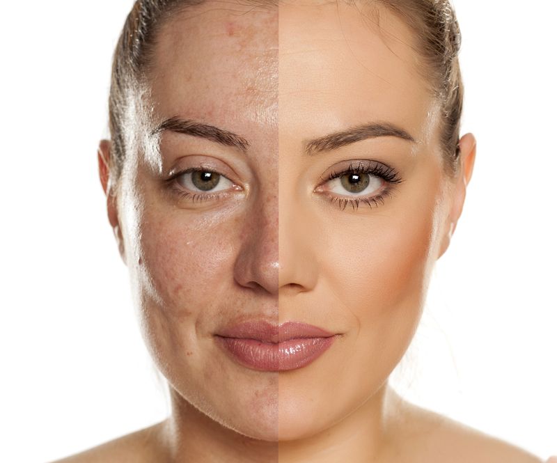 Close-up portrait of a person with neutral expression, makeup, and a light background