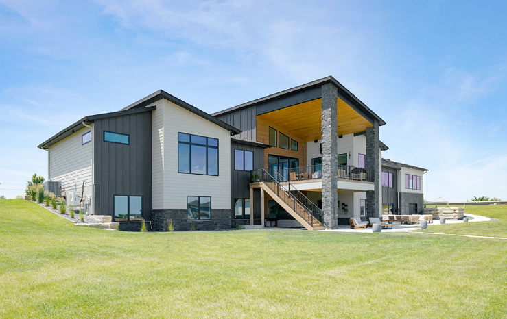Modern two-story house with black and light gray siding,