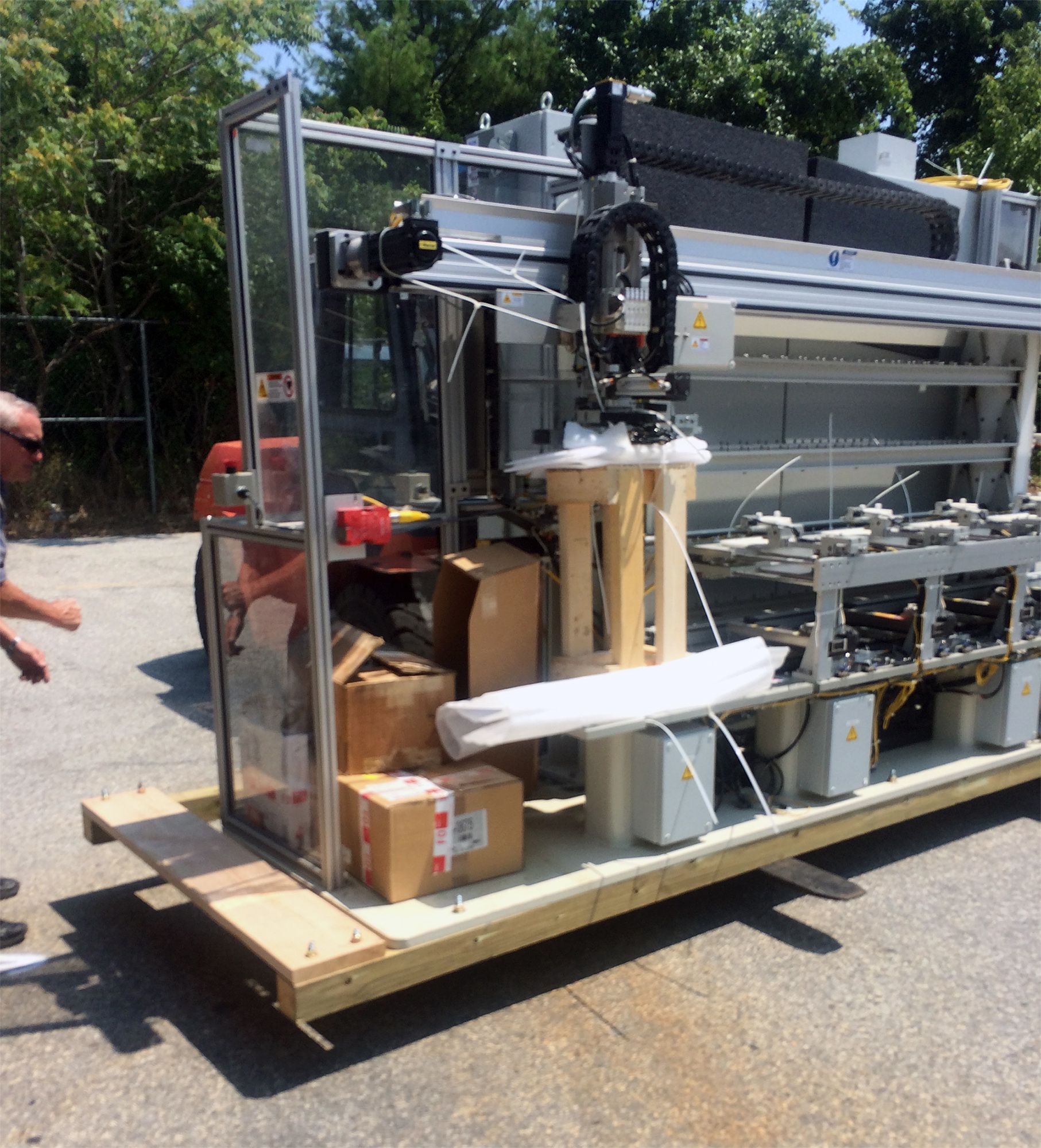 A man stands in front of a machine