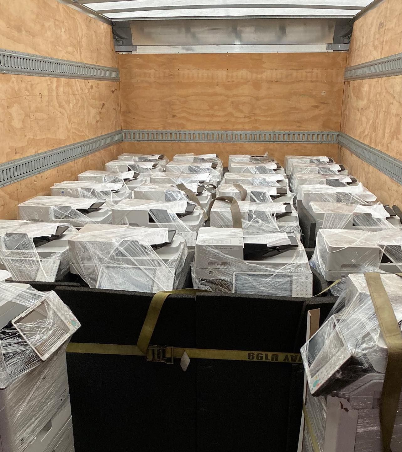 A truck filled with lots of boxes wrapped in plastic.