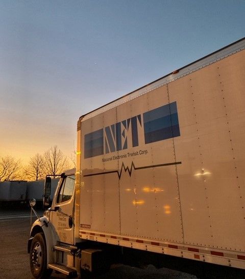 Side view of National Electronic Transit (N.E.T)'s truck