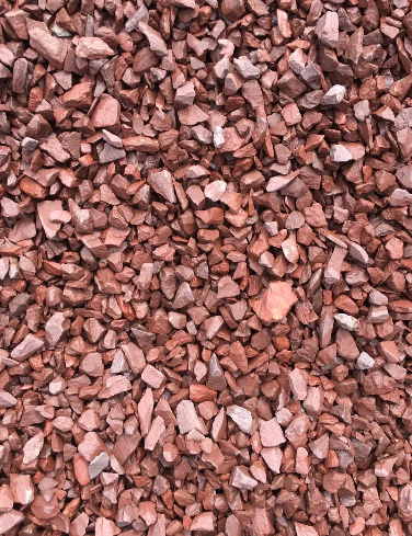 Reddish-brown crushed stone or gravel, ideal for landscaping or ground cover.