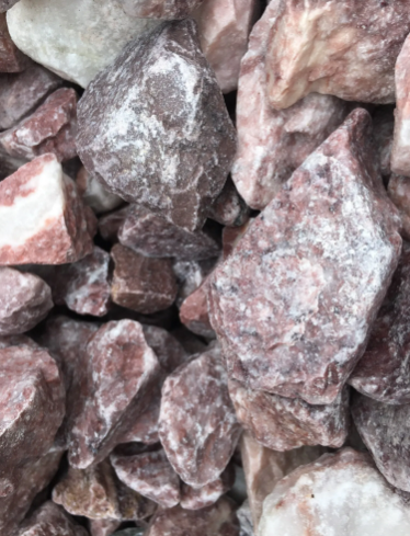 Pile of reddish-pink and white crushed gravel, likely for landscaping.