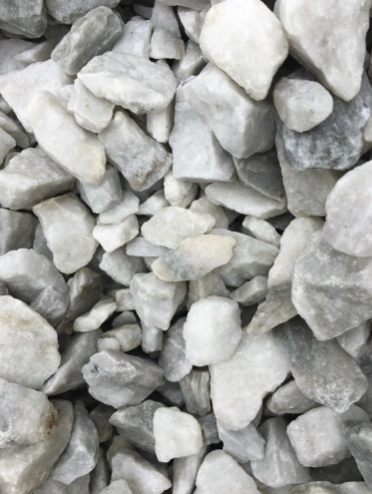 Pile of irregularly shaped white and gray rocks.