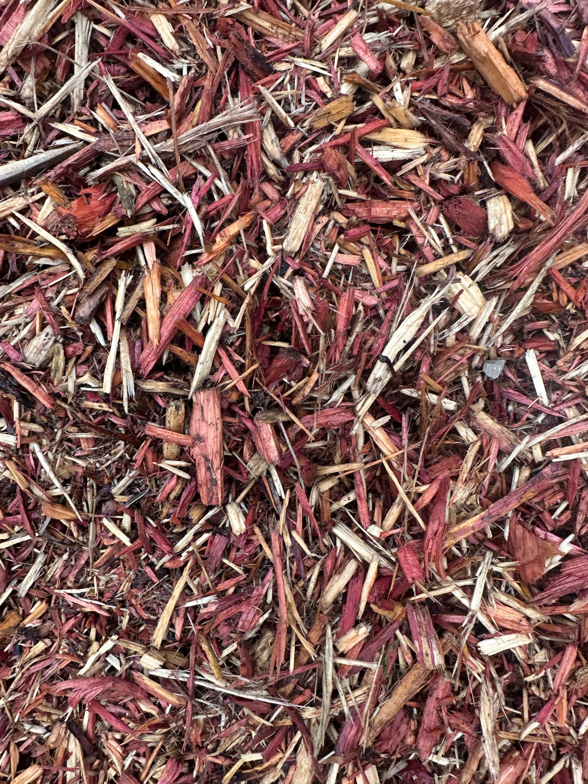 Reddish-brown wood chips scattered closely together, showing varying sizes and textures.