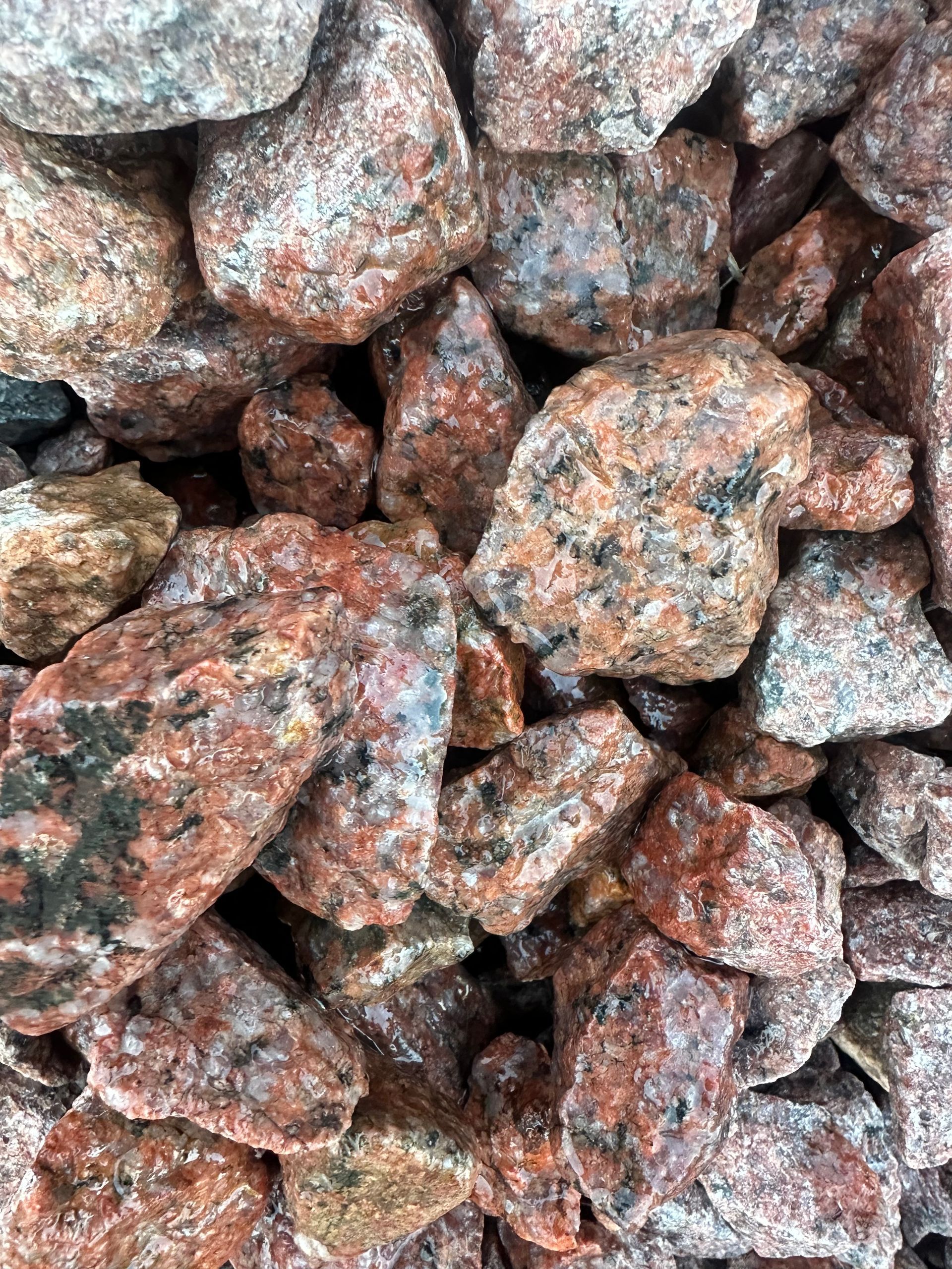 Red and gray granite rocks close-up, outdoors.