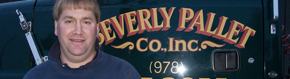 Man with Beverly Pallet Co Inc sign board