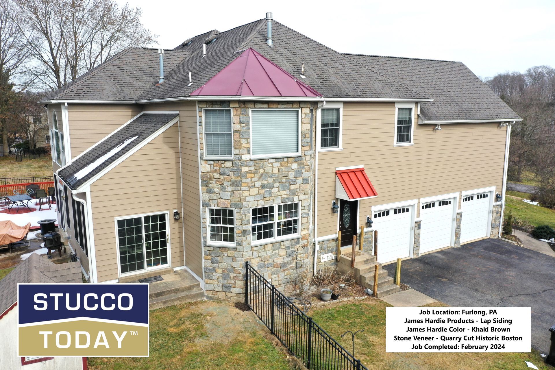 Two-story house with tan siding, stone facade, and red accents. Features three-car garage. 
