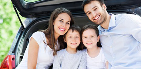 happy family behind a car
