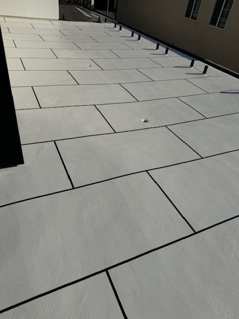 Tiled balcony after waterproofing, with sleek, sealed tiles.