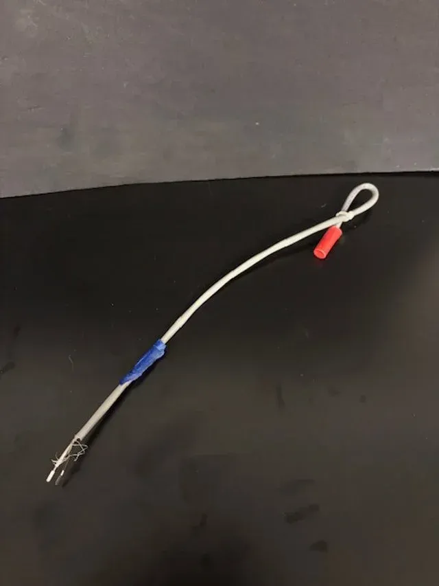 White cable with blue and red connectors on a dark surface