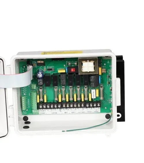 Open electrical control box with green circuit board and wiring inside a white enclosure
