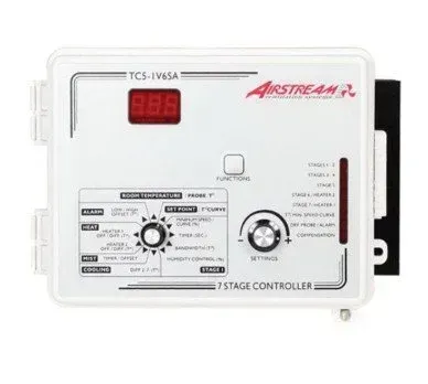 White thermostat controller with red digital display and two dials on a wall panel
