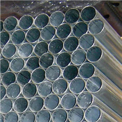 Close-up of stacked silver metal tubes with dark circular openings arranged in a tight bundle