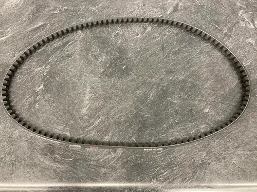 Black elastic belt or hair tie in an oval shape on a gray textured surface