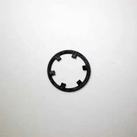 Black circular plastic ring with evenly spaced inner tabs on a white background