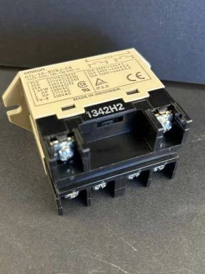 Black electrical relay module with beige label, shown on a gray surface.
