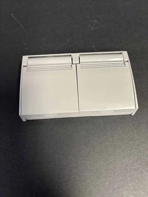 White dual-button wall switch on a dark surface
