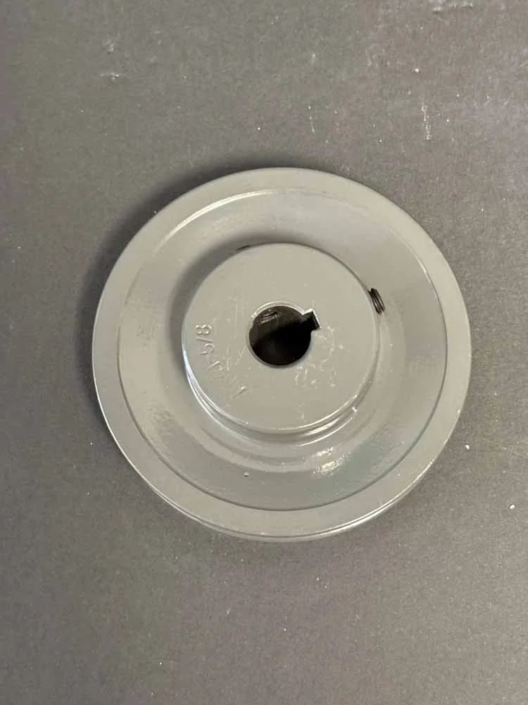 White circular ceiling mount with a central hole on a gray surface