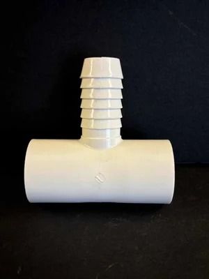 White plastic hose barb fitting on a black background