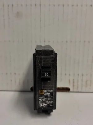 Black 20-amp circuit breaker with a yellow Square D logo against a light background