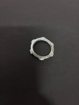 Silver metal ring on a dark surface