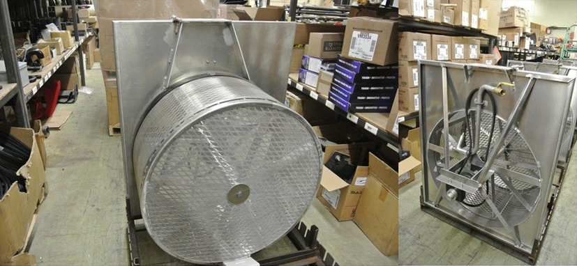 Large metal industrial equipment with a mesh drum, in a warehouse setting.