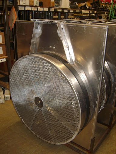 Large, stainless steel industrial filter with a diamond-patterned screen and rectangular inlet/outlet ducts.