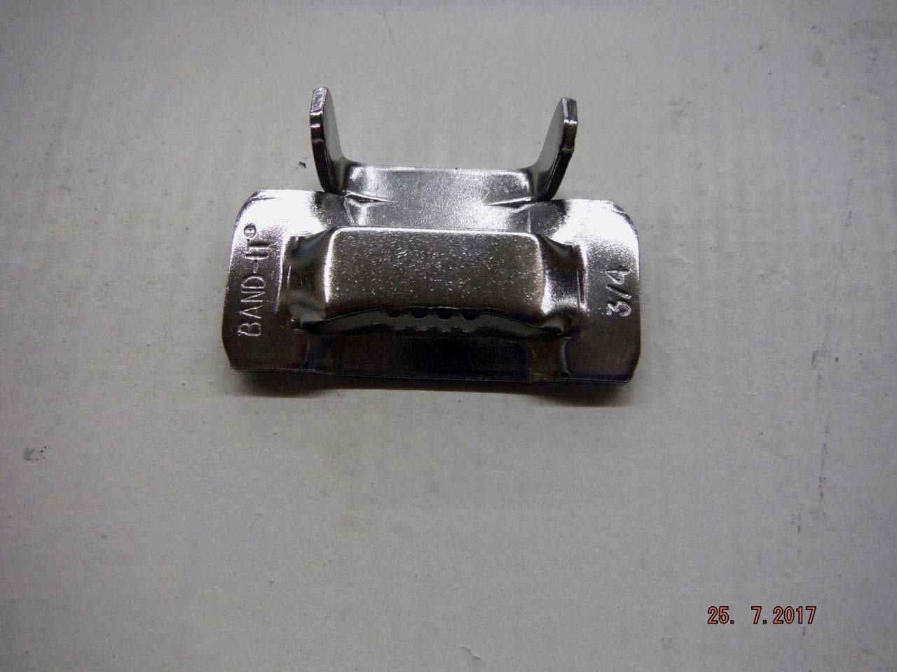 A shiny metal clamp, likely for securing something. It has two raised tabs and is labeled