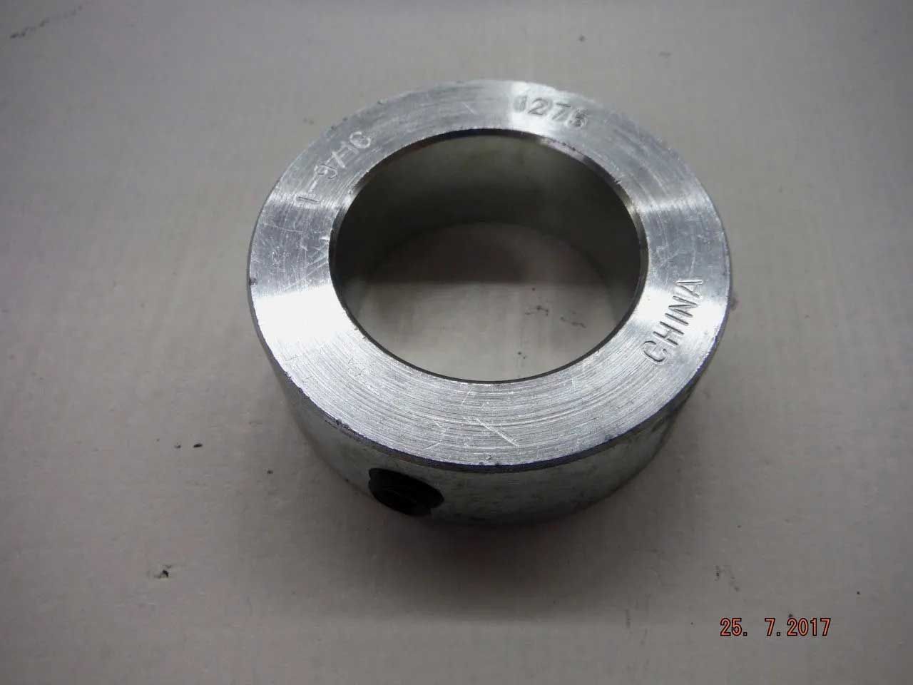 Close-up of a silver-colored collar with a hole and the word