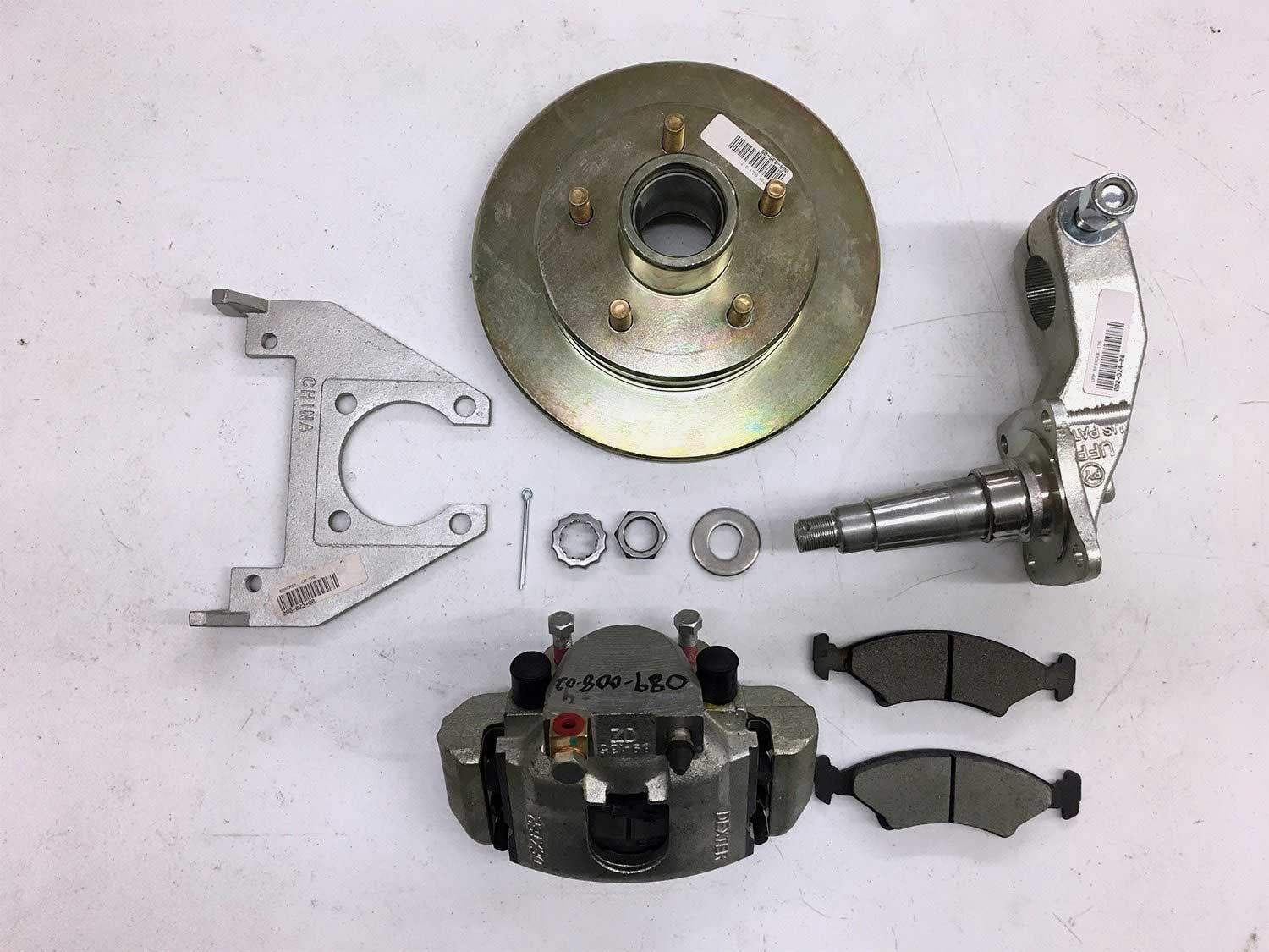 Disc brake kit with rotor, caliper, bracket, spindle, and brake pads.