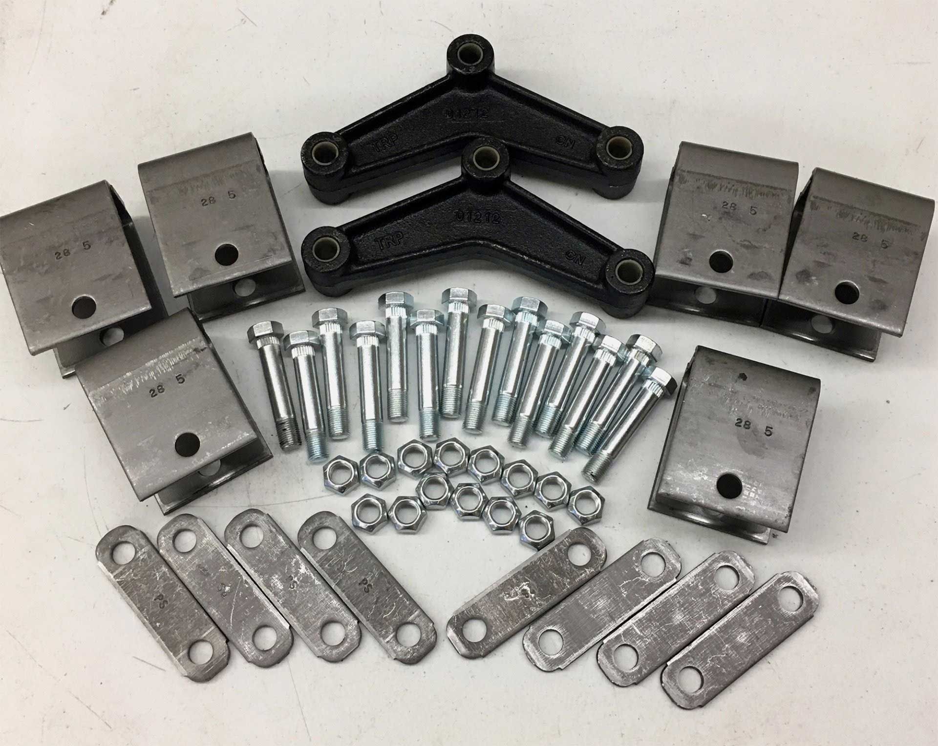 Trailer suspension parts kit with black equalizers, silver shackles, hanger brackets, and bolts and nuts.
