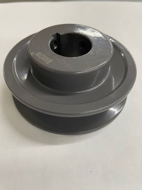 Gray pulley with a central hole and belt grooves.