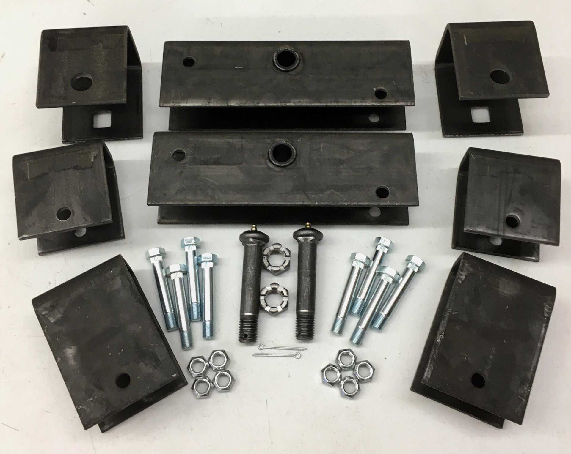 A kit of metal trailer suspension parts: brackets, spring hangers, bolts, pins, and nuts, arranged on a surface.