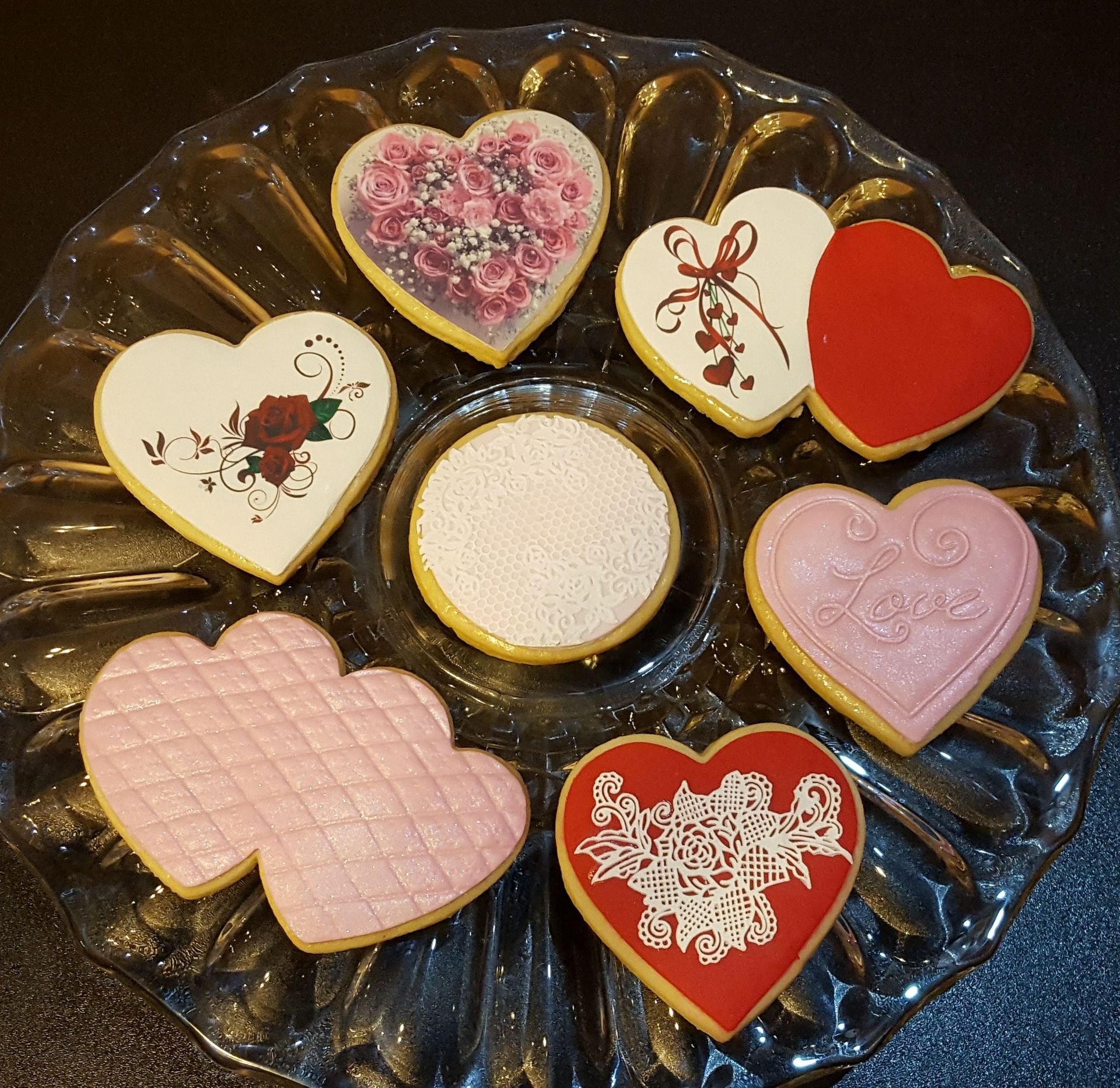 a glass plate with heart shaped cookies on it