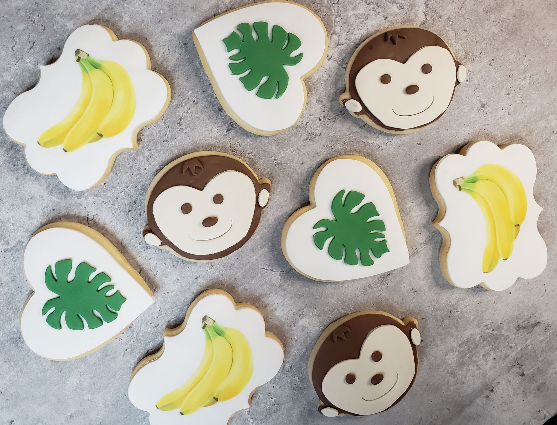 a bunch of cookies with monkeys and bananas on them