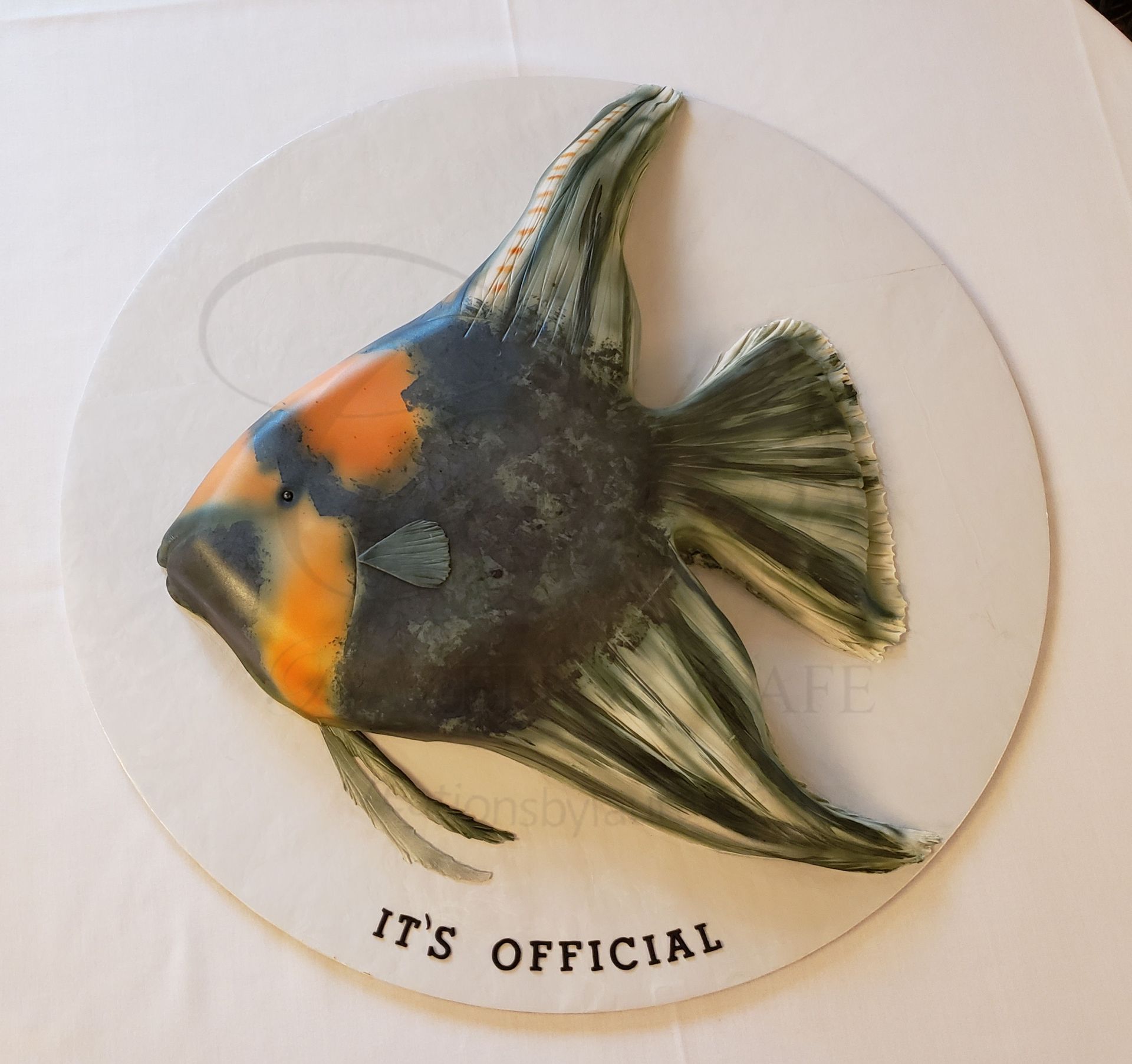 Round fish-shaped cake with orange and black stripes