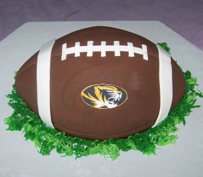 Chocolate football cake with white laces and green grass icing trim