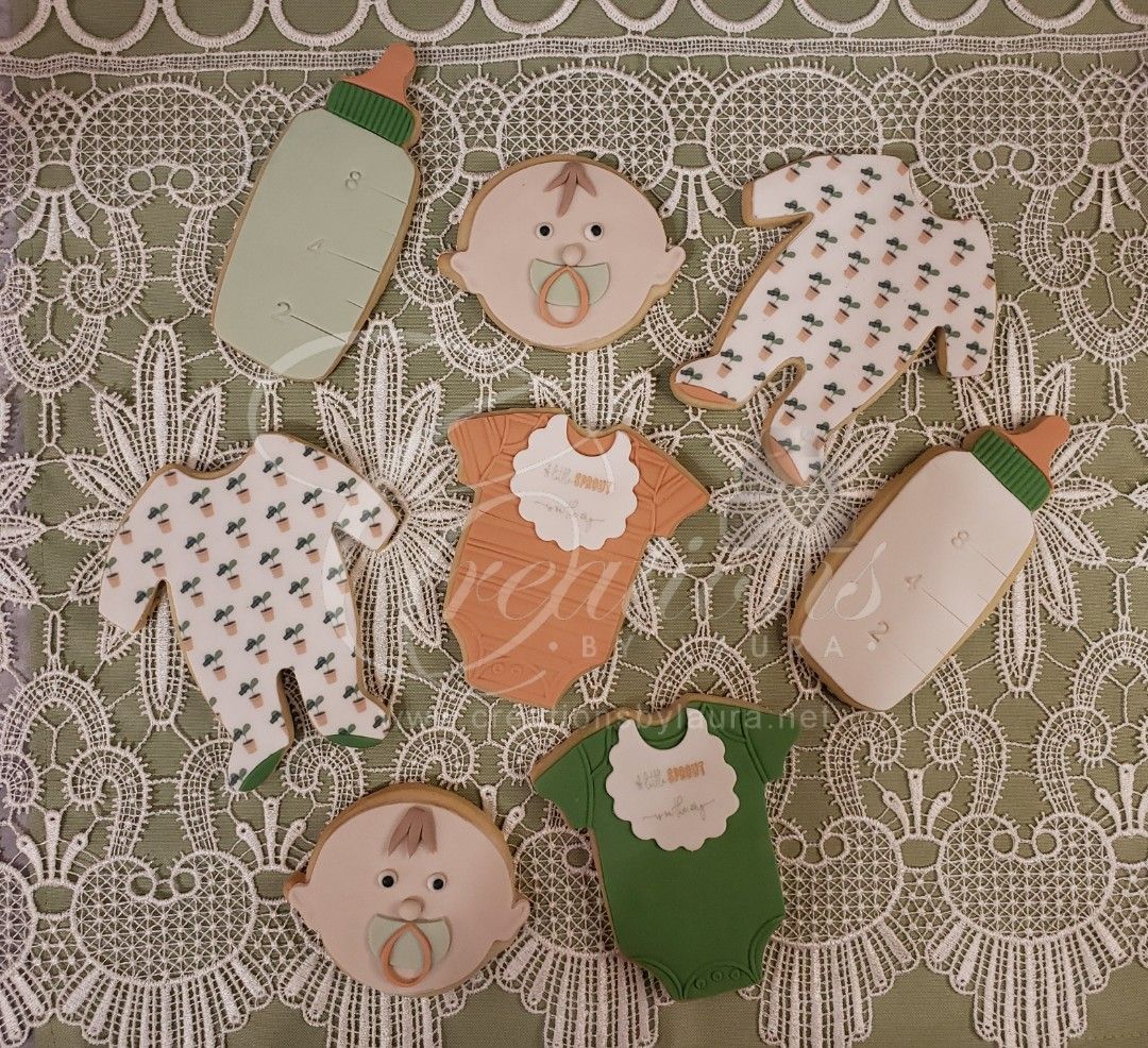 a bunch of baby themed cookies on a table