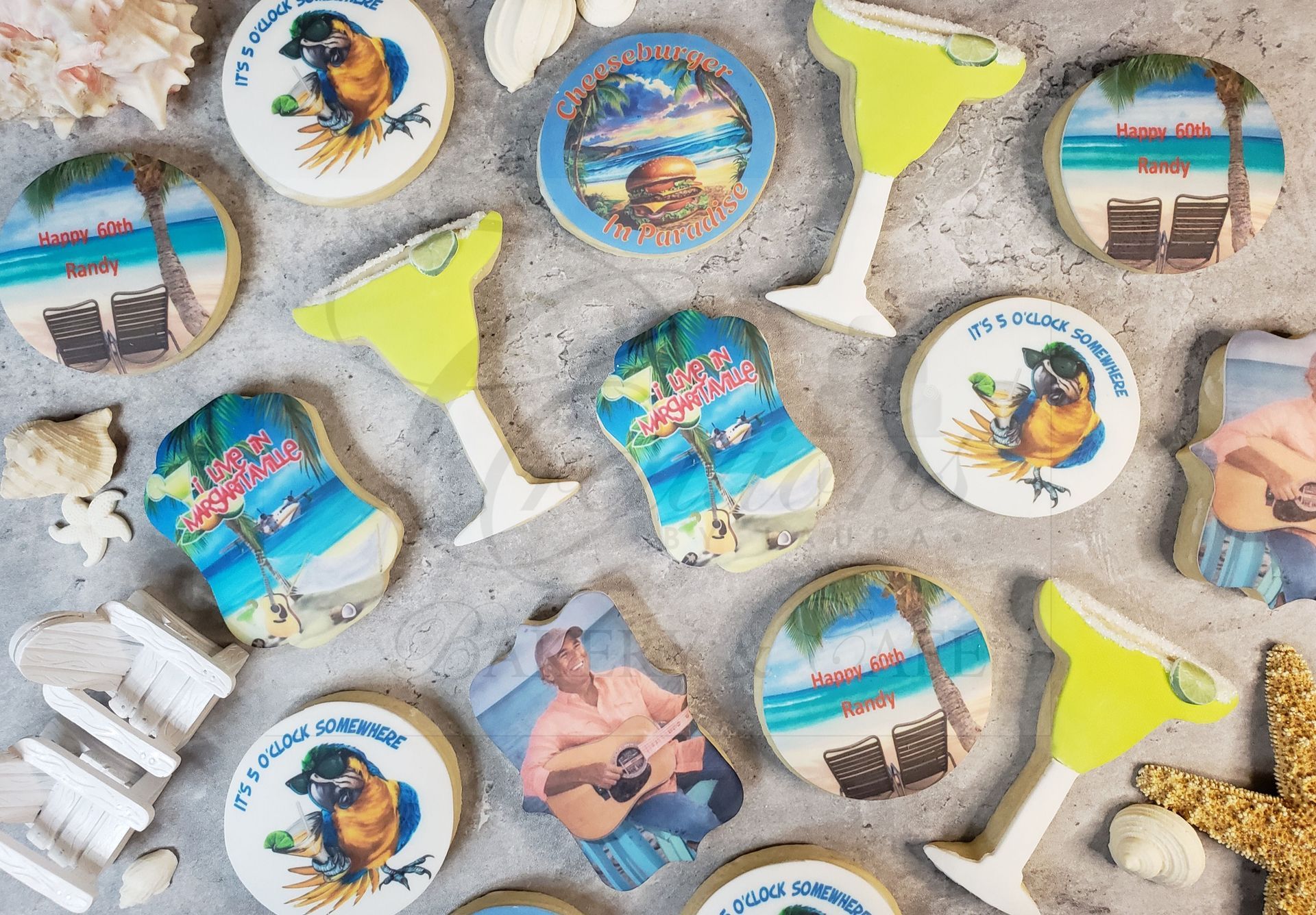 Assorted round beach-themed cookies and star decorations scattered on a gray surface.
