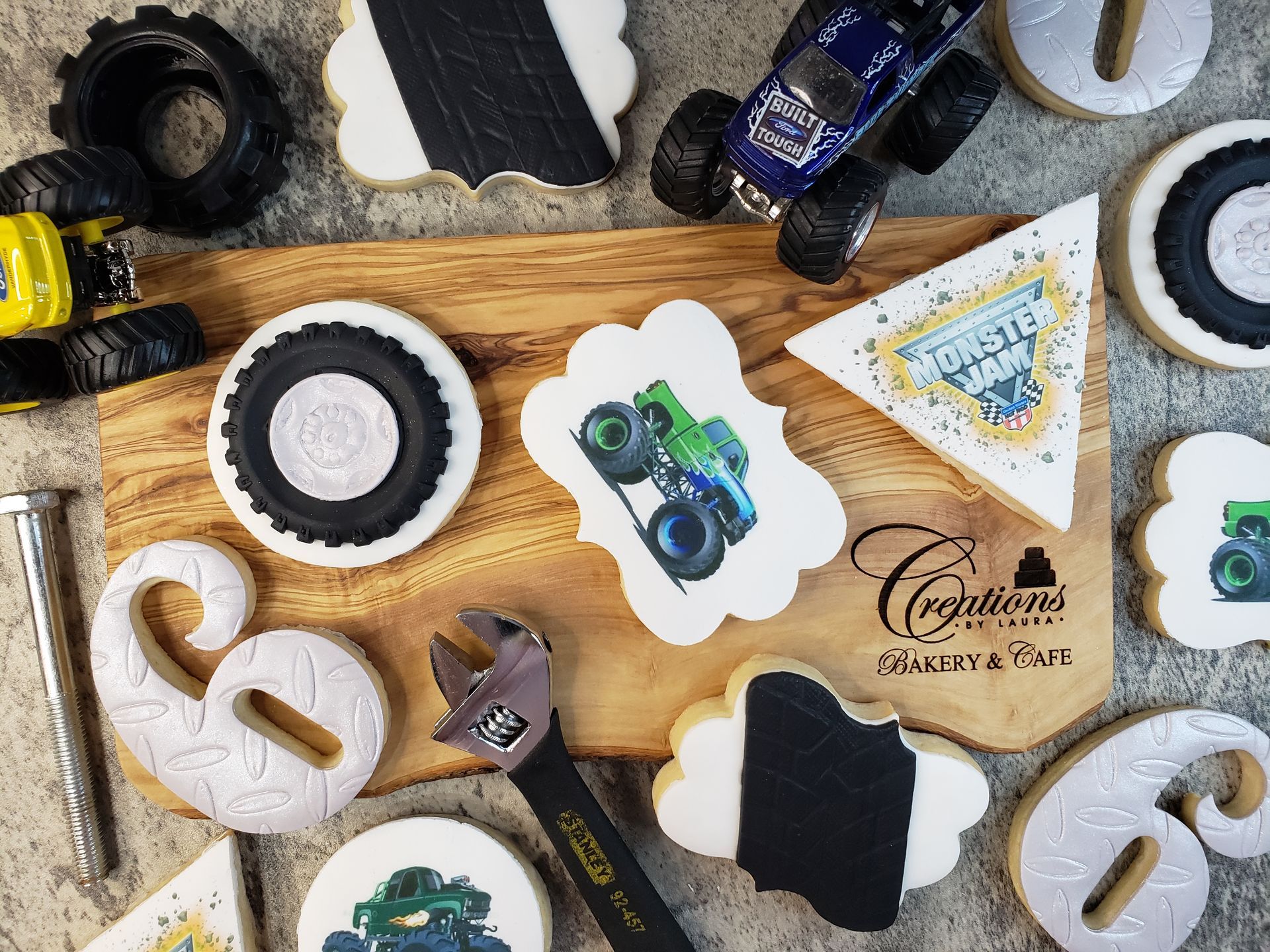 Assorted black-and-white cookie-shaped stickers and decorations on a wooden surface