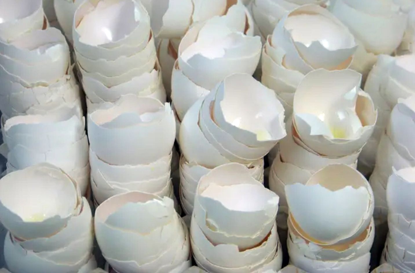 a large bowl of cake dough  is being mixed in a machine