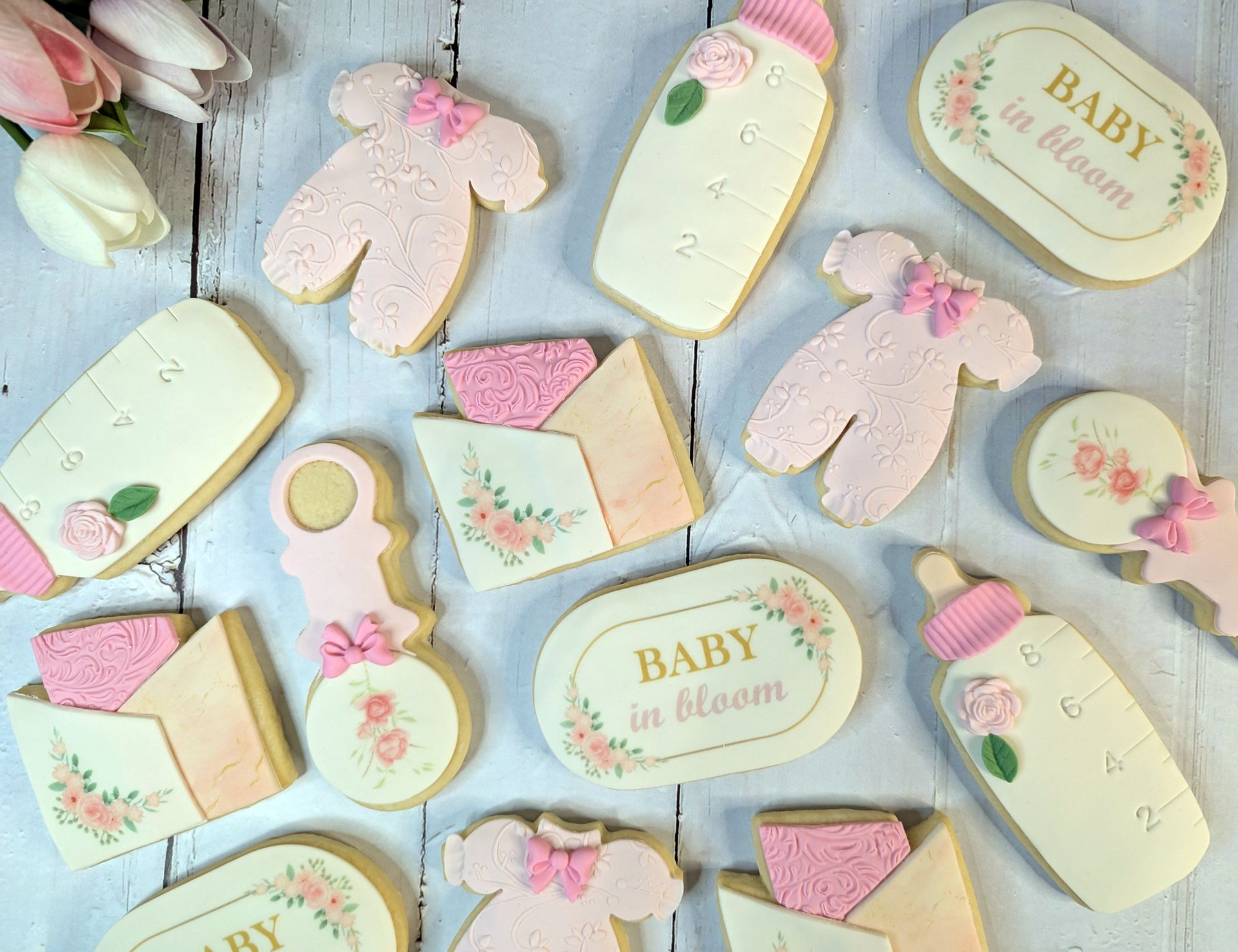 a bunch of baby themed cookies on a table