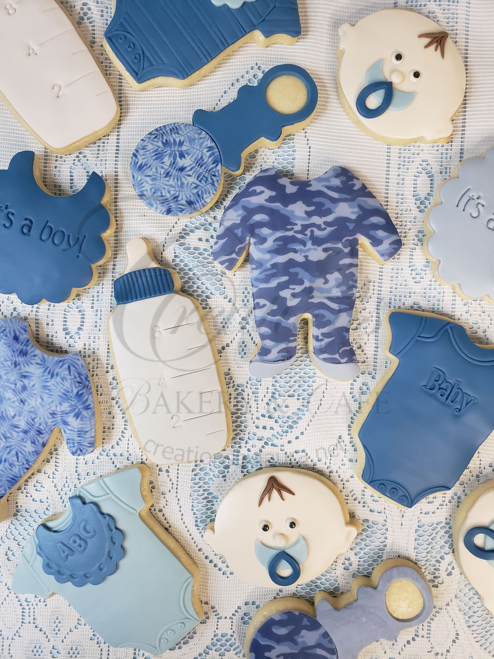 Blue and cream baby-themed quilt blocks with teddy bears, moons, and star accents
