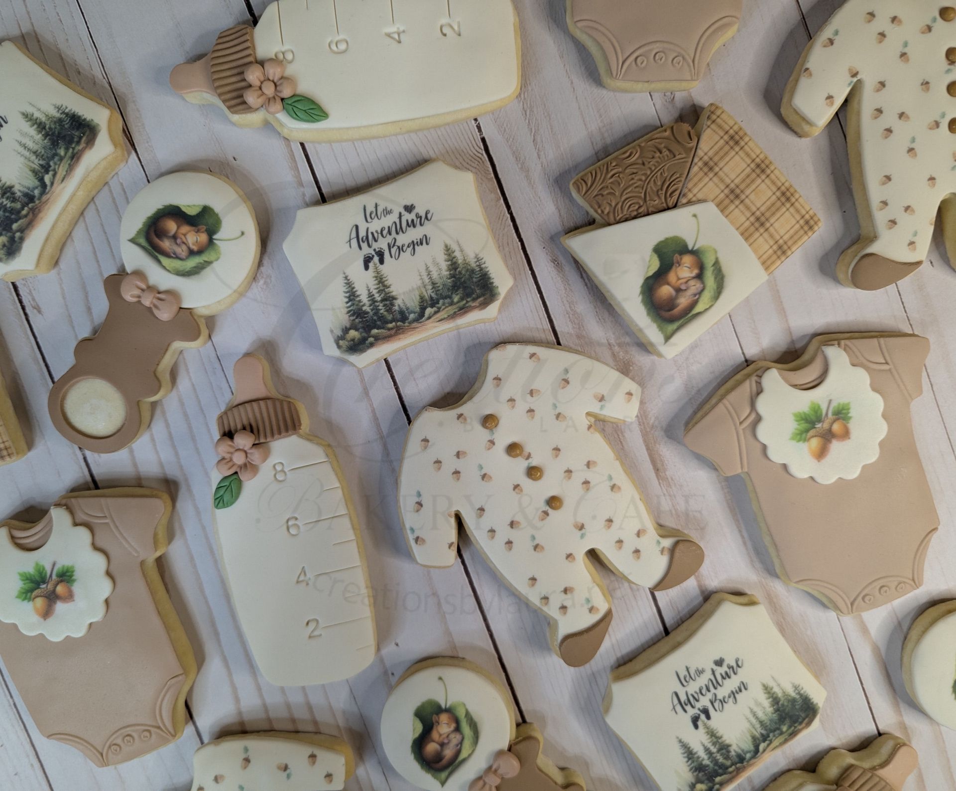 Assorted rustic baby-shower gift tags and ornaments in beige, white, and burlap on a light fabric background