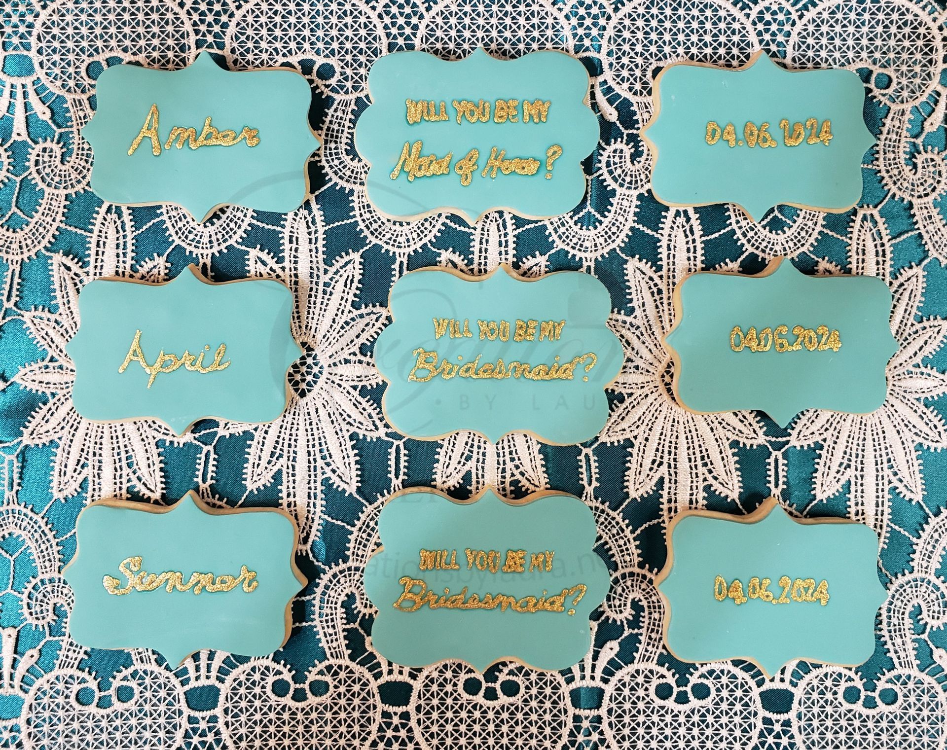 9 teal art-deco labels with gold lettering arranged in a 3x3 grid on a patterned lace background