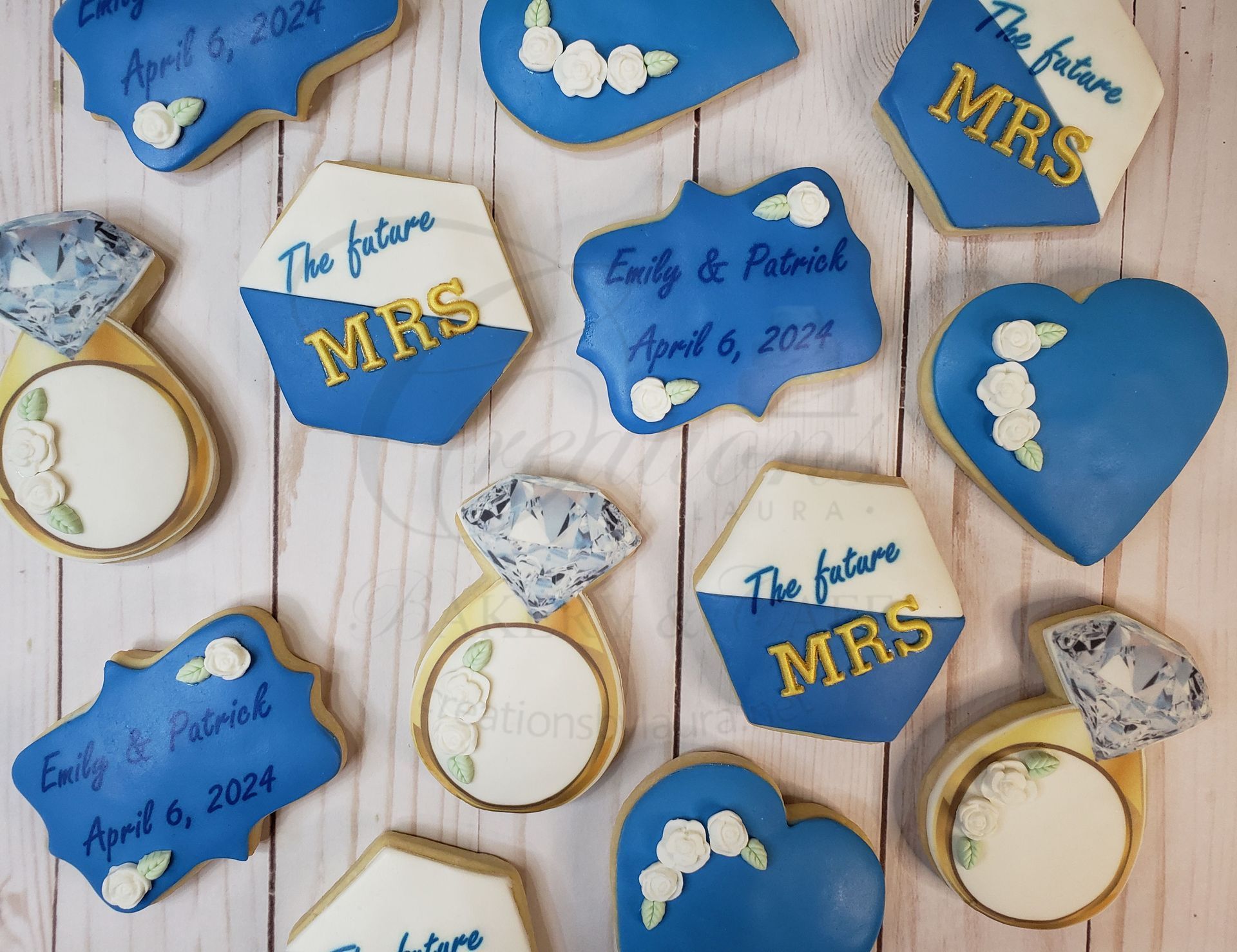 Blue and white wedding cookies with gold accents and Mr & Mrs text on a light wood table