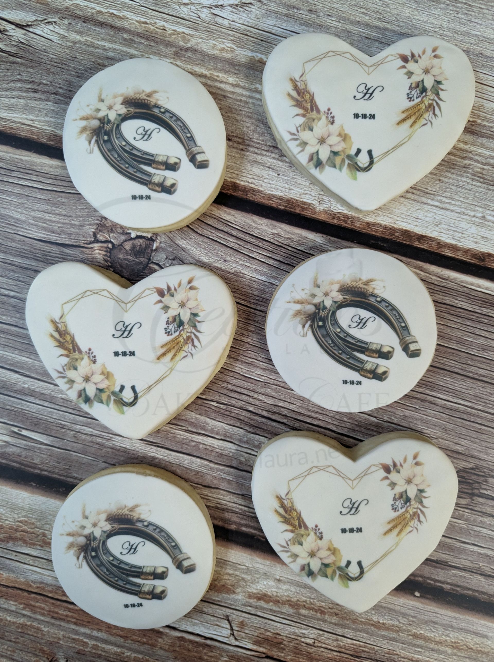 Six white heart and round keepsake ornaments with gold floral accents on a wood surface